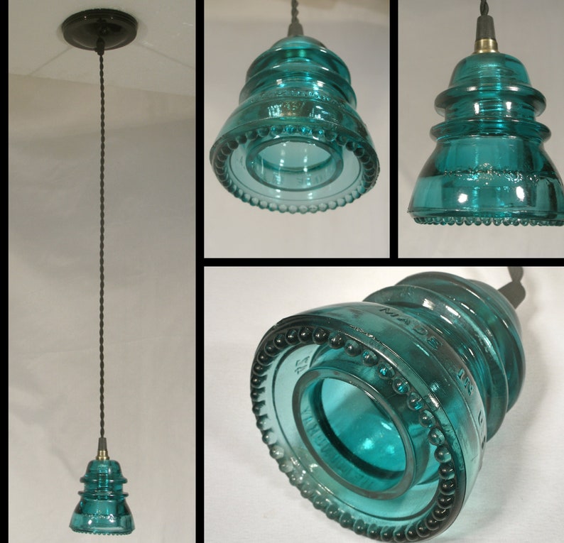 May include: A teal blue glass insulator pendant light fixture with a beaded rim. The light fixture is suspended from a black cord and has a black ceiling mount.
