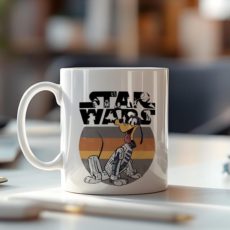May include: White ceramic mug with a Star Wars design featuring a cartoon dog in a spacesuit. The dog is set against a striped background. The Star Wars logo is above the dog.