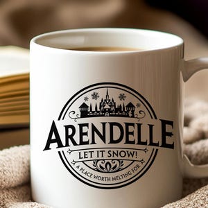 May include: White ceramic mug with a black circular design featuring the word "Arendelle" and the phrase "Let It Snow!" The design includes a castle silhouette and snowflakes. The mug is filled with a warm beverage.
