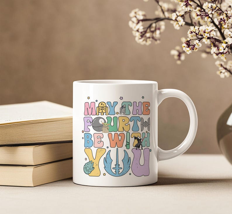 May include: White ceramic mug with a colorful graphic that says "May the Fourth Be With You" and features characters from Star Wars.