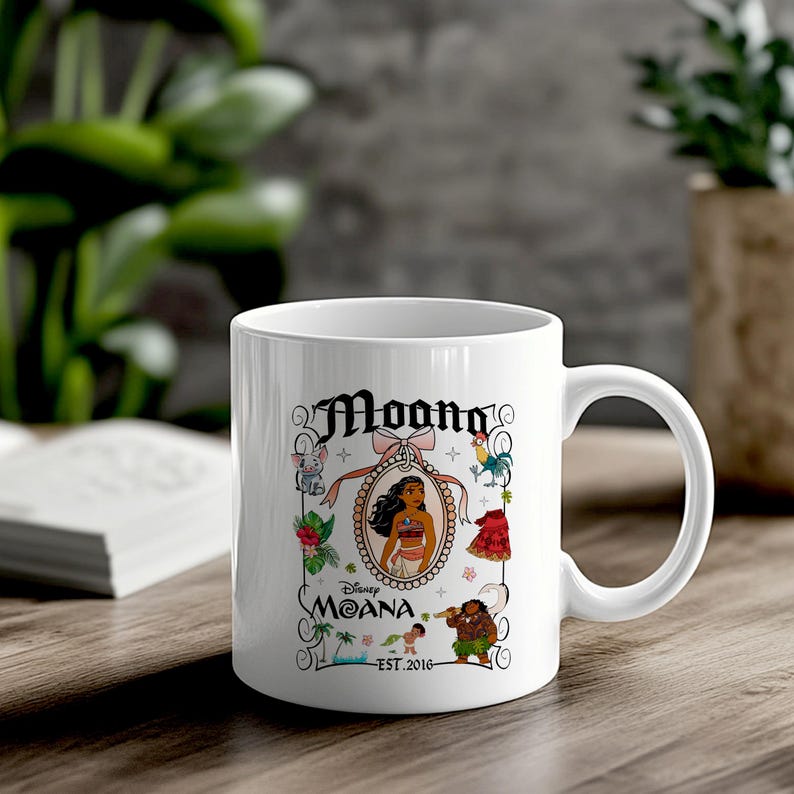 May include: White ceramic coffee mug featuring a colourful illustration of Moana from Disney's Moana. The illustration includes Moana, Maui, Pua the pig, Hei Hei the rooster, and a floral design. The text "Moana" and "Est. 2016" are printed on the mug.