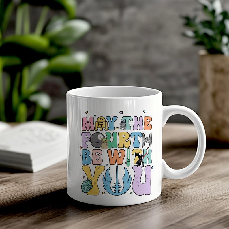 May include: White ceramic mug with a colorful design that says "May the Fourth Be With You". The design includes various Star Wars characters and symbols.