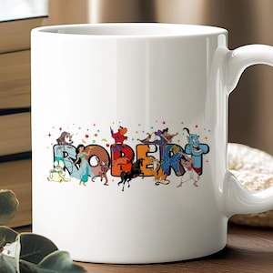 May include: White ceramic mug featuring the name "ROBERT" in colorful, cartoon-style letters. Each letter is decorated with characters from a popular animated movie. The mug has a curved handle and is set against a blurred background.