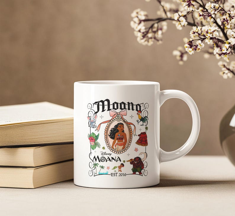 May include: White ceramic coffee mug featuring a colourful illustration of Moana from Disney's Moana. The illustration includes Moana, Maui, Pua the pig, Hei Hei the rooster, and the ocean. The text "Disney Moana Est. 2016" is printed on the mug.