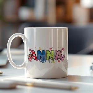 May include: White ceramic mug with the name "ANNA" printed in colorful letters. Each letter features a different character from the animated movie Lilo & Stitch, with floral accents.