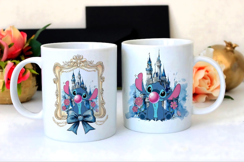 May include: Two white ceramic mugs featuring a blue cartoon character with large ears and a pink bubble. One mug has the character in a gold frame with a blue bow. The other mug has a castle background.
