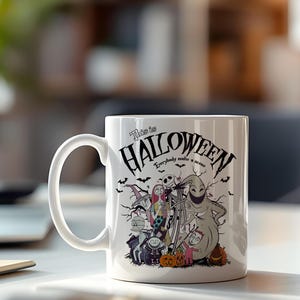 May include: White ceramic mug featuring a Halloween-themed design with characters and the text "This is Halloween." The design includes Jack Skellington, Sally, and Oogie Boogie, along with bats and pumpkins. The mug has a curved handle.