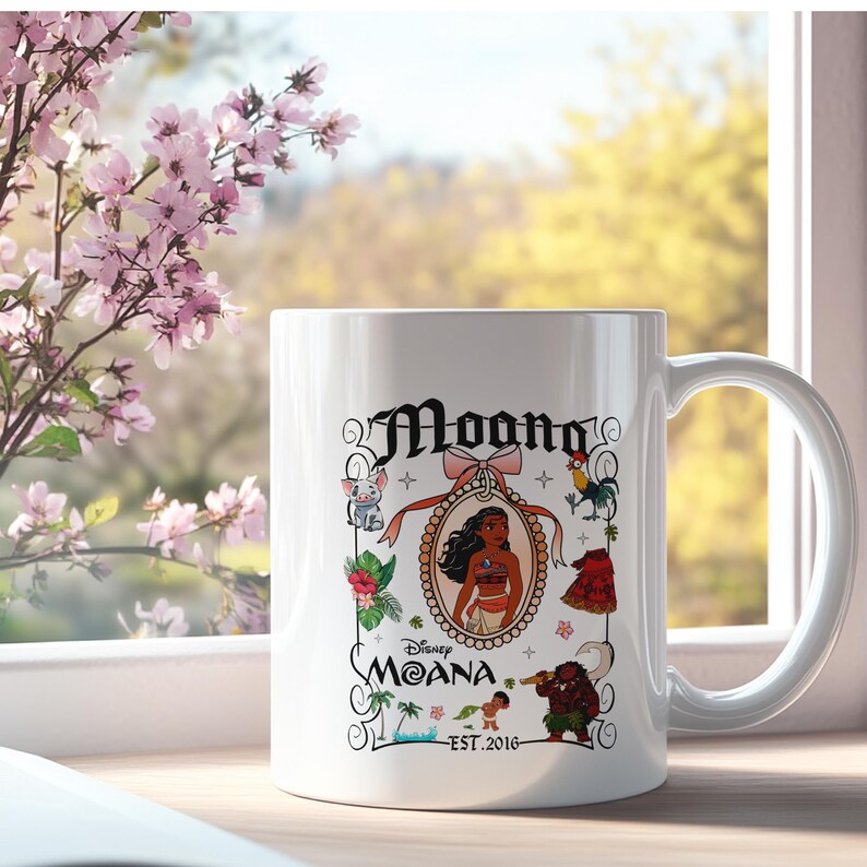 May include: White ceramic mug with a colourful design featuring Moana from the Disney movie Moana. The design includes Moana in a frame, a rooster, a pig, a flower, and the text "Moana Est. 2016".