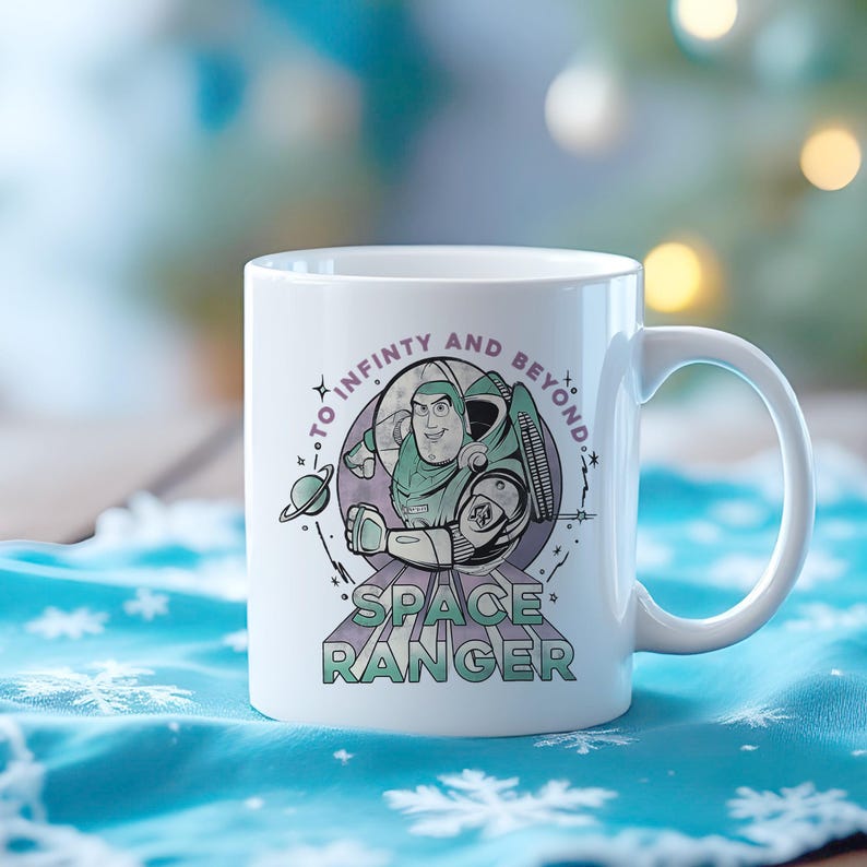 May include: White ceramic mug with a cartoon space ranger illustration and the text "TO INFINITY AND BEYOND" and "SPACE RANGER". The design features a planet and stars in green, purple, and white. A classic mug for fans.
