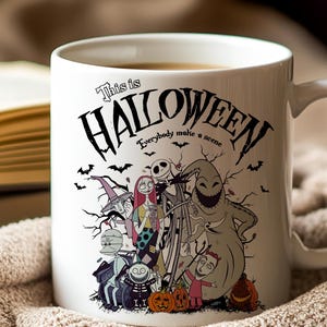 May include: White ceramic mug featuring a Halloween-themed design with characters and the text "This is Halloween." The design includes Jack Skellington, Sally, Oogie Boogie, and other characters from the movie. The mug has a curved handle.