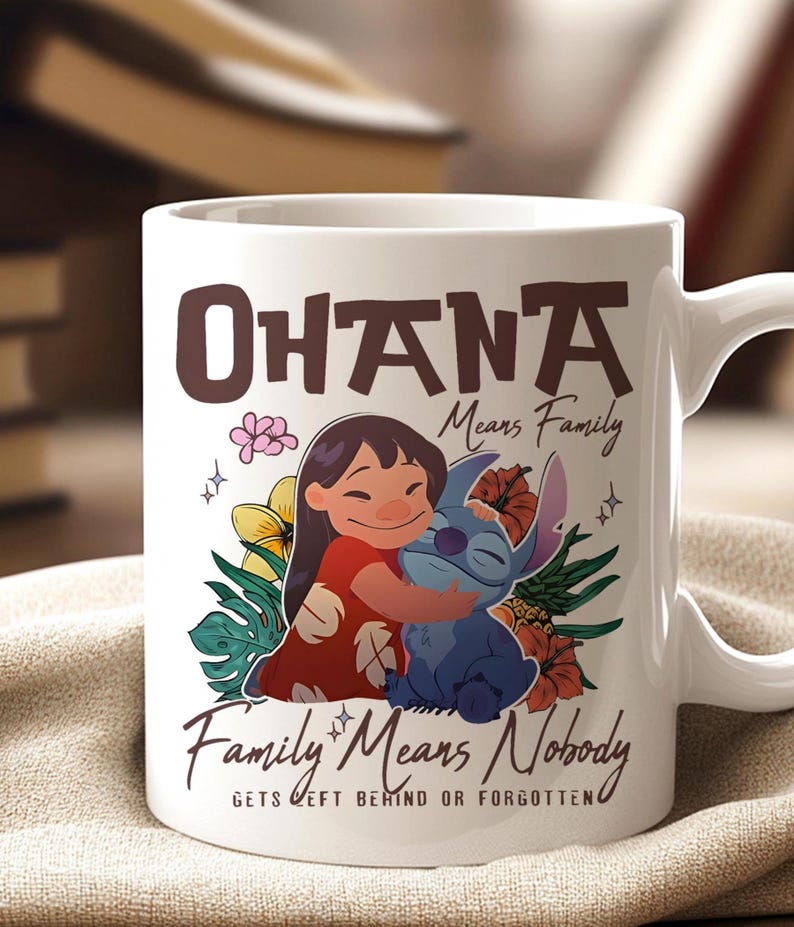 May include: White ceramic mug with a colourful illustration of Lilo and Stitch embracing, surrounded by flowers. The mug features the text "Ohana Means Family" and "Family Means Nobody Gets Left Behind or Forgotten."