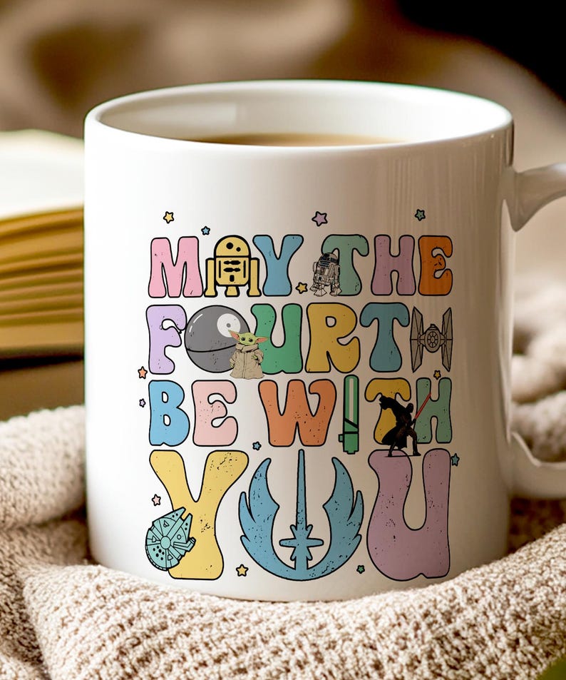 May include: White ceramic coffee mug with a colorful graphic that says "May the Fourth Be With You" and features various Star Wars characters.