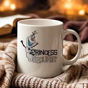 May include: White ceramic mug featuring a cartoon snowman character with the text "PRINCESS SECURITY" in black. The snowman has a blue mouth and a carrot nose. The mug has a large handle.