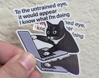 May include: A sticker featuring a black cat with white markings, typing on a laptop. Text above the cat reads "To the untrained eye, it would appear I know what I'm doing."