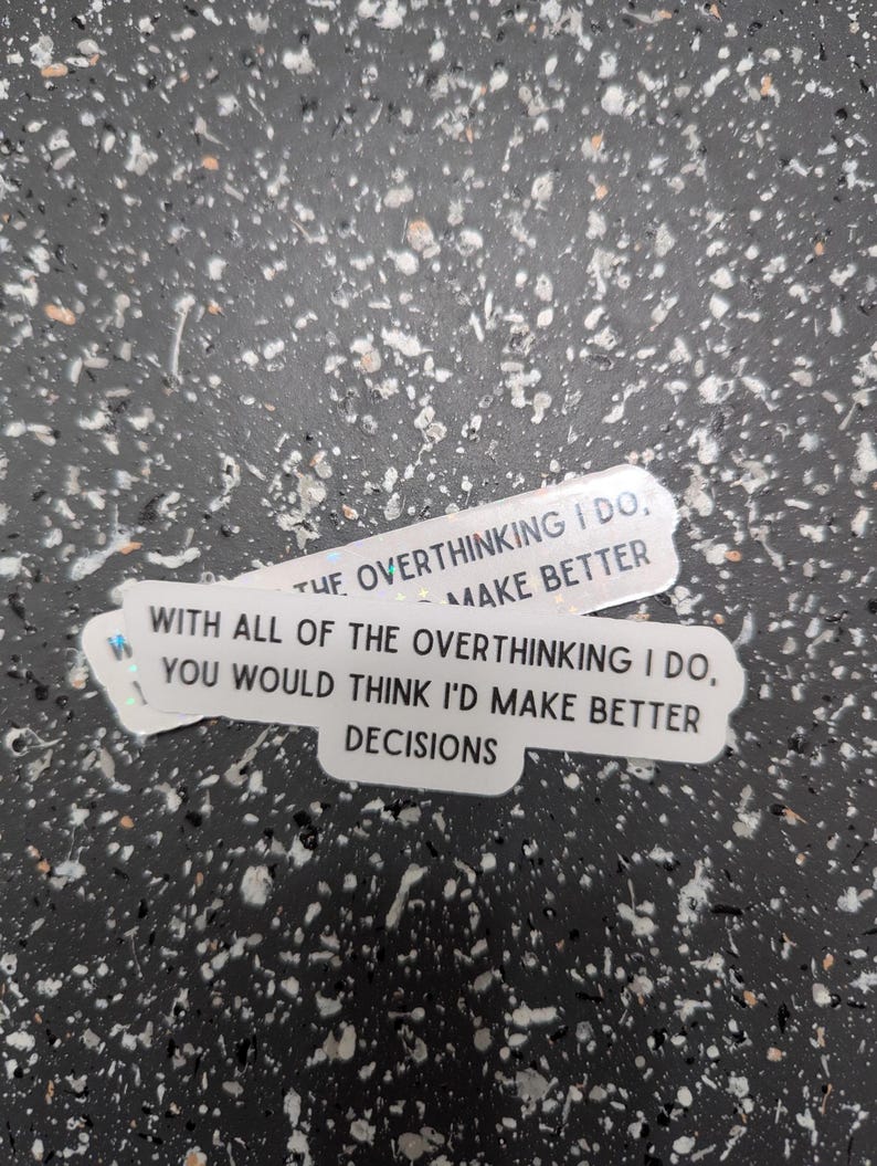 May include: Two white stickers with black text on a speckled background. The stickers read: "THE OVERTHINKING I DO, MAKE BETTER" and "WITH ALL OF THE OVERTHINKING I DO, YOU WOULD THINK I'D MAKE BETTER DECISIONS."