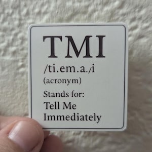May include: A white square sticker with the acronym "TMI" in bold black letters. Below the acronym is the phonetic pronunciation, followed by "(acronym)" and the phrase "Stands for: Tell Me Immediately."
