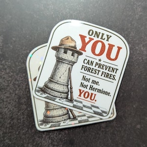 May include: A square sticker with rounded corners featuring a gray stone chess rook wearing a brown ranger hat. The text reads: ONLY YOU CAN PREVENT FOREST FIRES. Not me. Not Hermione. YOU. The design includes a wand leaning against the rook.