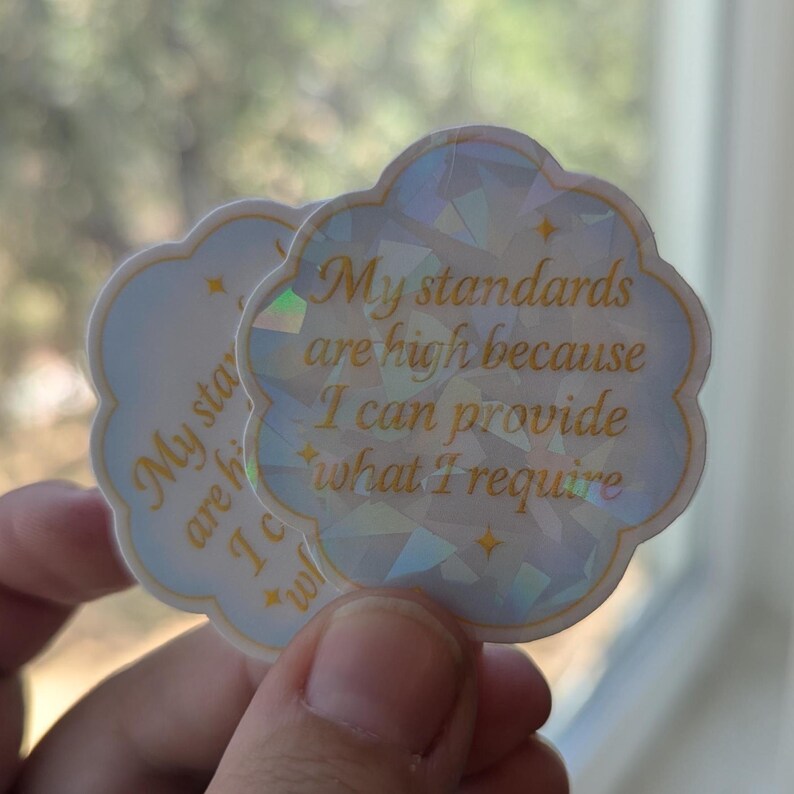 May include: Two cloud-shaped stickers with the text "My standards are high because I can provide what I require" in gold lettering. The stickers have a light blue background with a geometric design and gold stars.