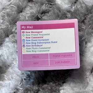 May include: A rectangular pink and white card with the words "My Mail" at the top. The card lists various message types, including "New Messages!" and "New Friend Requests!" with corresponding icons. The bottom has the words "inbox", "friend requests", "sent", and "post bulletin".