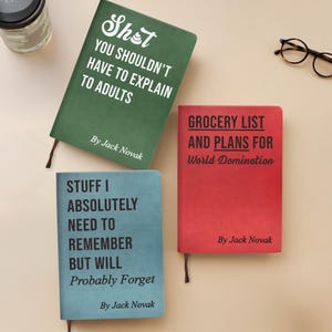 May include: Three notebooks in green, red, and blue, each with a different title. The green notebook reads "Sh*t You Shouldn't Have to Explain to Adults." The red notebook says "Grocery List and Plans for World Domination." The blue notebook says "Stuff I Absolutely Need to Remember But Will Probably Forget."