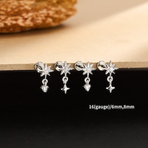 May include: Four silver-colored earrings with star and heart charms. Each earring has a star-shaped top with a dangling star or heart charm. The text "16(gauge)/6mm,8mm" is visible.