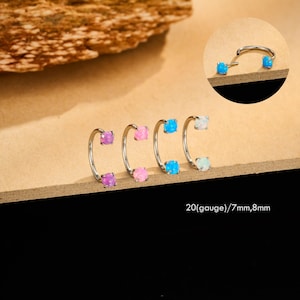 May include: A collection of horseshoe-shaped earrings with colorful square gemstones. The earrings are silver-toned and feature purple, pink, blue, and white stones. The image also includes a close-up of one earring. The text on the image reads: 20(gauge)/7mm,8mm.