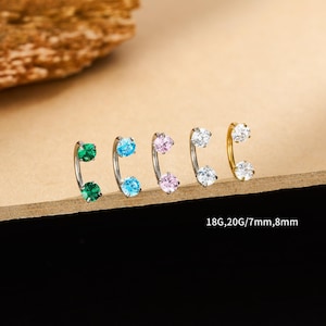 May include: Five curved barbell earrings with colorful gemstones. The earrings are silver and gold-toned, each featuring two round, sparkling stones in green, blue, pink, and white. Text on the image reads: 18G,20G/7mm,8mm.