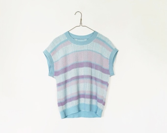 May include: A light blue sleeveless sweater with horizontal stripes in a pale purple color. The sweater is hanging on a wire hanger against a white background.