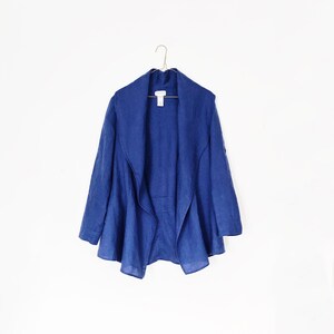 May include: A blue linen cardigan with a wide, open collar and a relaxed fit.