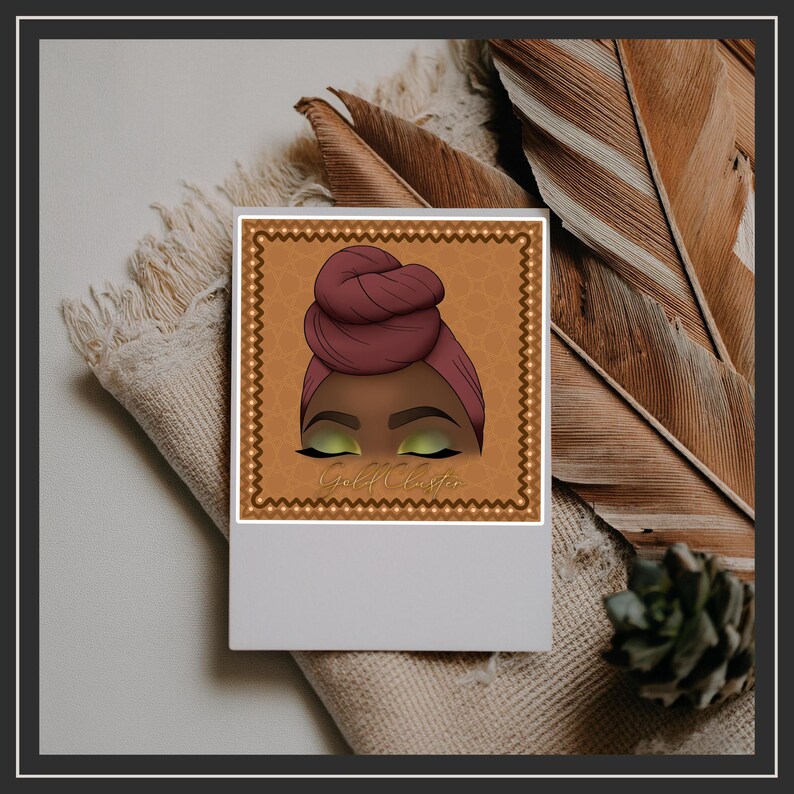 May include: A square print featuring an illustration of a person with a burgundy head wrap and green eyeshadow. The illustration is set against a gold background with the text "Gold Classie". The print is on a white surface.