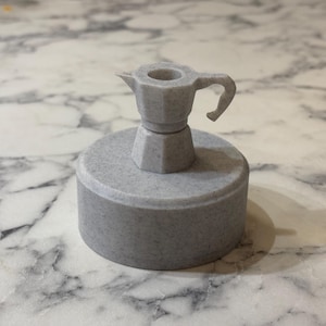 May include: A gray ceramic coffee pot with a handle and a spout, sitting on a gray ceramic base.