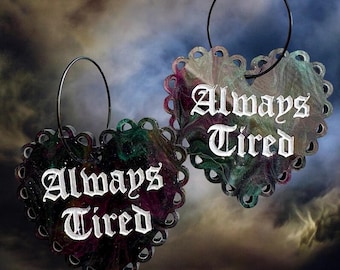 Always Tired-haunted black purple green shimmer pearl laser cut acrylic hearts on black enamel hoops.