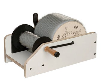 May include: A white wooden spinning wheel with a black handle and a silver metal drum with a pattern of animals on it. The drum is covered in small metal teeth.