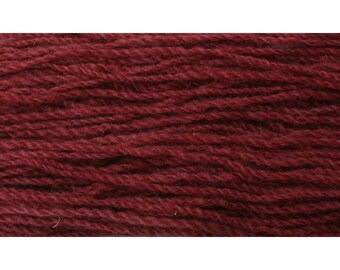May include: A skein of deep red wool yarn. The yarn is tightly spun and has a smooth texture.