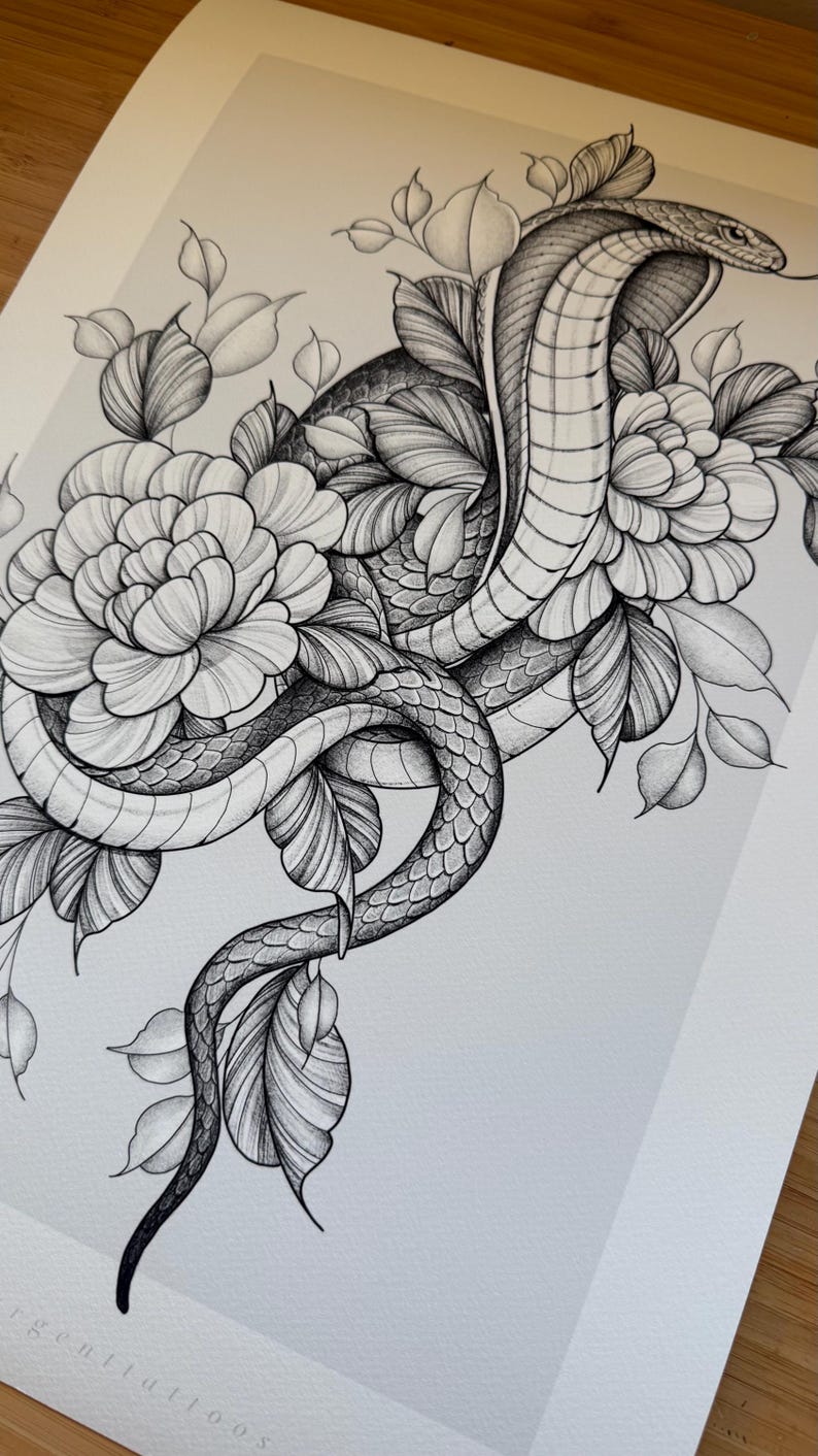 May include: Detailed black and white illustration of a cobra intertwined with flowers and leaves. The snake is the focal point, with scales and intricate details. The floral elements add a delicate contrast to the snake's form.