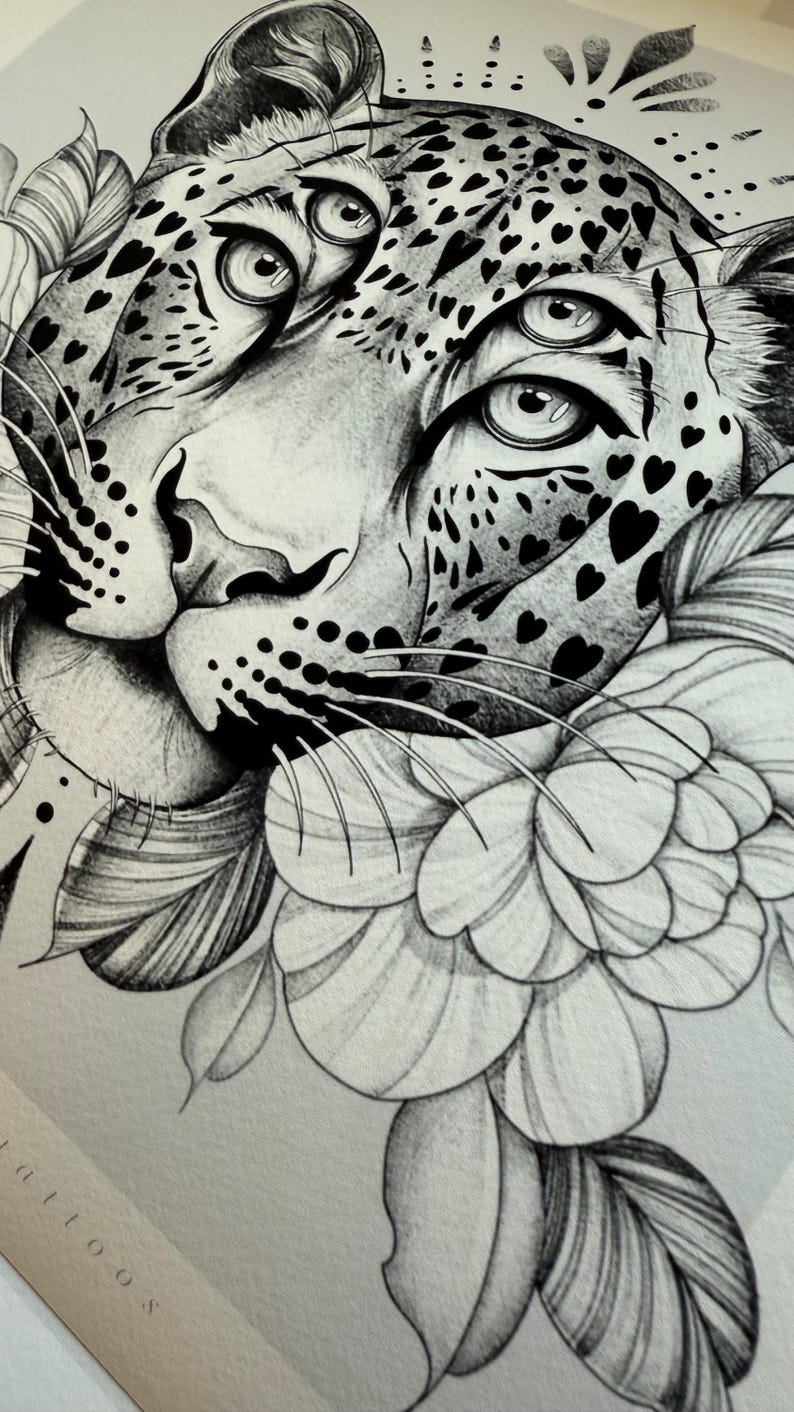 May include: Detailed black and white illustration of a leopard's face, featuring heart-shaped spots and a floral element. The leopard's eyes are prominent, and the artwork has a realistic style. The image is a close-up, focusing on the animal's features.