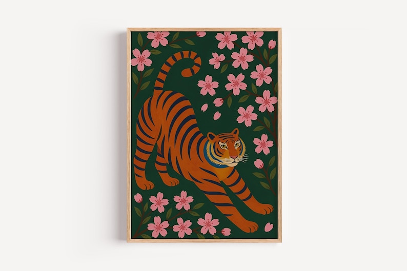 May include: A framed art print featuring an orange tiger with black stripes stretching among pink cherry blossoms and green leaves against a dark green background. The artwork has a minimalist, illustrative style.