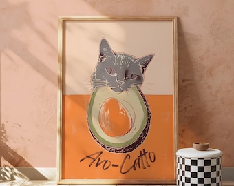 May include: A framed print of a gray cat with its head inside a halved avocado. The text "Avo-Catt" is written below the avocado.