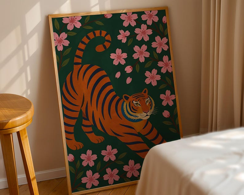 May include: A framed art print featuring a stylized tiger with orange and black stripes, set against a dark green background with pink cherry blossoms. The tiger is in a stretching pose, creating a dynamic composition.