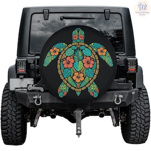 May include: Black spare tire cover featuring a colorful turtle design. The turtle is composed of orange, blue, and green tropical flowers and leaves. The cover is mounted on the back of a black Jeep.