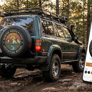 May include: A dark green SUV with a spare tire cover featuring a mountain and river design. The cover has the text "Wander Wraps Studio" and "Adventure Bound." A smartphone displays the cover design with color options.