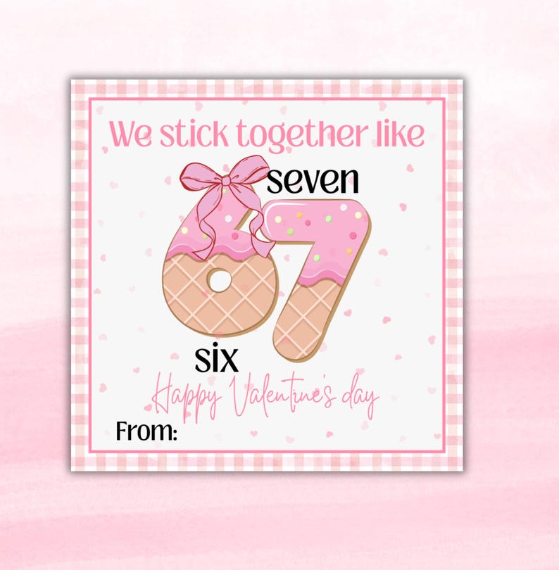 May include: A Valentine's Day card with a pink and white gingham border. The card features a pink frosted number six and seven, designed to look like cookies. The text reads "We stick together like seven six Happy Valentine's day" and "From:"
