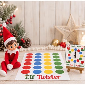 May include: A small elf doll in a red suit and hat sits next to a white game board featuring rows of red, blue, yellow, and green circles with the text Elf Twister. A square spinner board on a wooden easel shows Left Hand, Right Foot, Left Foot, and Right Hand.