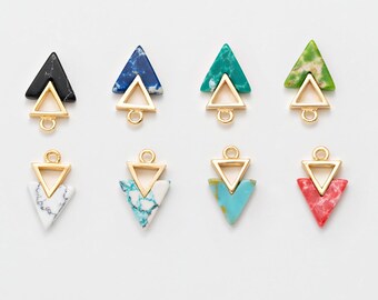 May include: A collection of eight geometric triangle charms in various colors and textures. Each charm features a gold-colored metal frame with a small loop for attaching to jewelry. The triangles are black, blue, green, white, turquoise, and red.