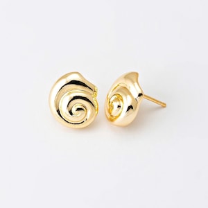 Könnte beinhalten: Ein Paar goldfarbene Ohrstecker. Jeder Ohrring ist wie eine spiralförmige Muschel geformt. Die Ohrringe werden auf weißem Hintergrund präsentiert. Die Ohrringe haben eine polierte, reflektierende Oberfläche.