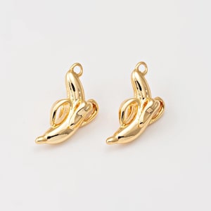 May include: Two gold-colored banana charms, each with a loop at the top for attaching to jewelry or other crafts.
