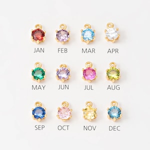 May include: Twelve gold charms with different colored crystals, each representing a month of the year.  January is red, February is purple, March is blue, April is clear, May is green, June is lavender, July is pink, August is green, September is blue, October is pink, November is yellow, and December is blue.