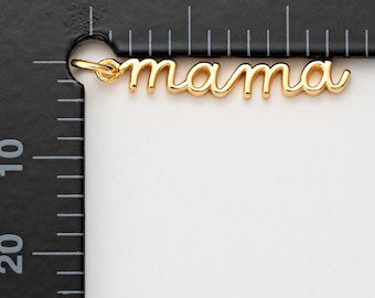 May include: Gold-colored metal charm with the word "mama" written in cursive.