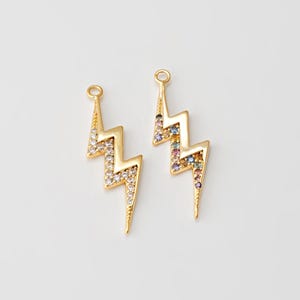 May include: Two gold-tone lightning bolt charms with clear and multi-colored crystal accents.