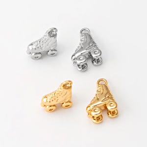 May include: Four silver and gold roller skate charms. The charms are detailed with wheels and laces. The charms are perfect for adding a fun and sporty touch to jewellery.